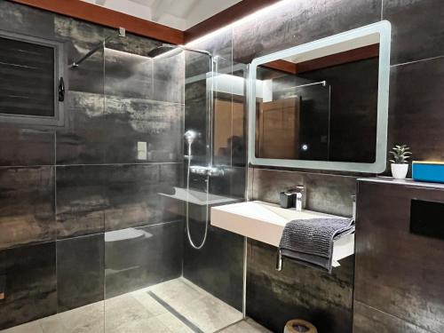 a bathroom with a sink and a mirror at Villa passion vanille in Les Trois-Îlets