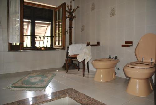 a bathroom with a toilet and a sink and a window at Il Ghiro B&B in Riccò del Golfo di Spezia