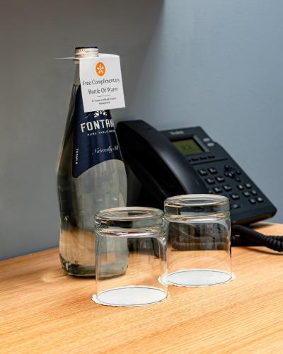 a bottle of wine and two glasses on a desk at Ta' Tereza In Manwel Dimech in Sliema