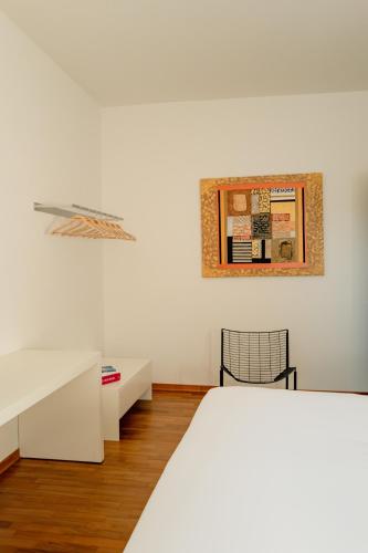 a bedroom with a bed and a table and a picture at Albereto 41 in Calenzano
