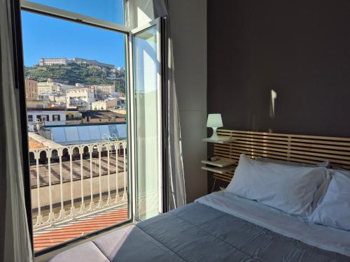 a bedroom with a bed and a large window at Appartamento Annunziata in Naples