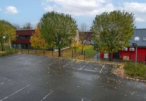 an empty parking lot in front of a building at B&B HOTEL Laval Changé in Changé
