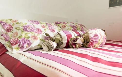 a bed with colorful pillows and bows on it at Il Podestà in Fabriano