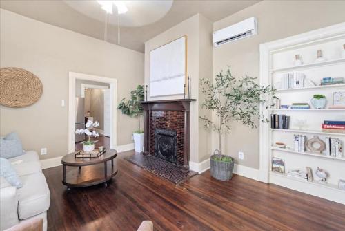 a living room with a couch and a fireplace at Historic Suite Downtown Macon - Unit 2 in Macon