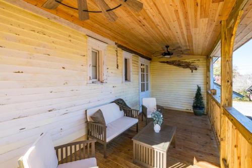 a porch of a wooden cabin with chairs and a table at Historic Suite Downtown Macon - Unit 2 in Macon