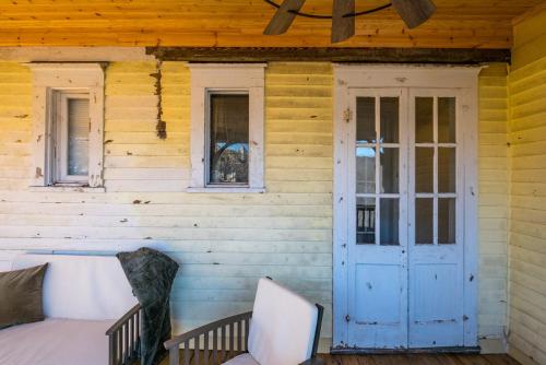 a porch of a wooden house with a blue door at Historic Suite Downtown Macon - Unit 2 in Macon