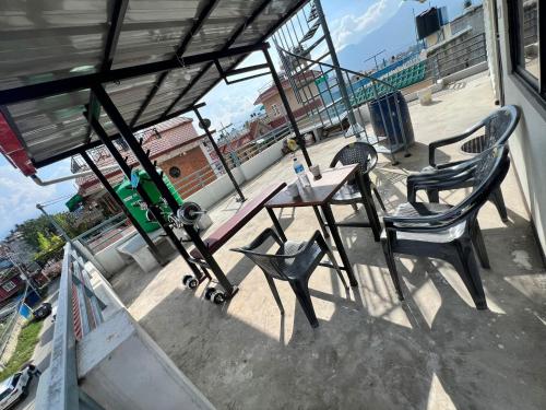 a table and chair with a skateboard on a balcony at Bethany Homestay Self-catering in Pātan
