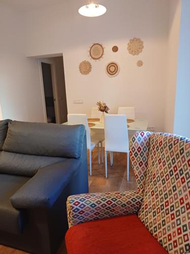 a living room with a couch and a table at VUT Casa de la Catedral Baja in Sigüenza