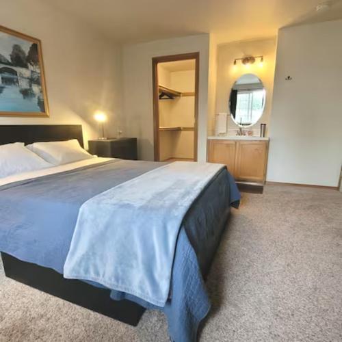 a bedroom with a large bed and a bathroom at Sunstone House in Portland