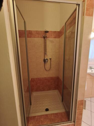 a shower with a glass door in a bathroom at Atmosphere Guest House Rubiera in Rubiera