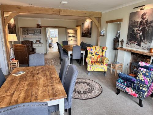 a living room with a wooden table and chairs at Forces Manor in Kincraig