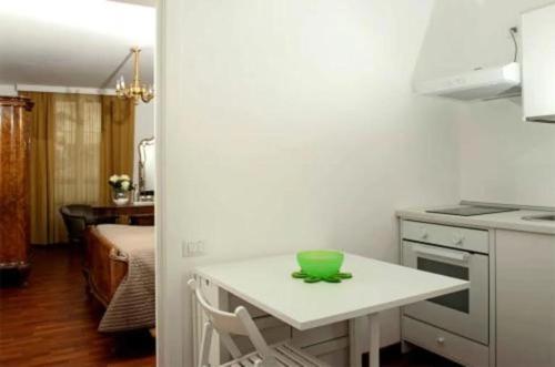 a kitchen with a table with a green bowl on it at Il Podestà in Fabriano