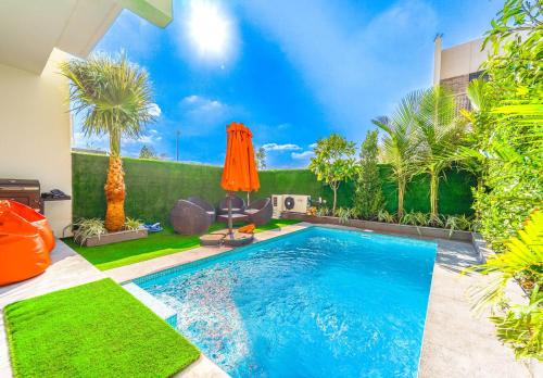 a swimming pool in the backyard of a house at Dubai Private Pool villa Damac Hills 2 deleguest in Dubai