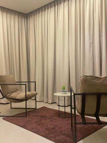 a living room with two chairs and a table at Ceylan trees in Kataragama