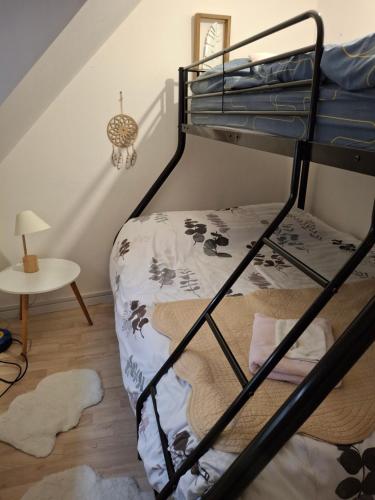 a bedroom with a bunk bed and a table at maison village 4 chambres 30 minutes du zoo de beauval in Saint-Cyran-du-Jambot