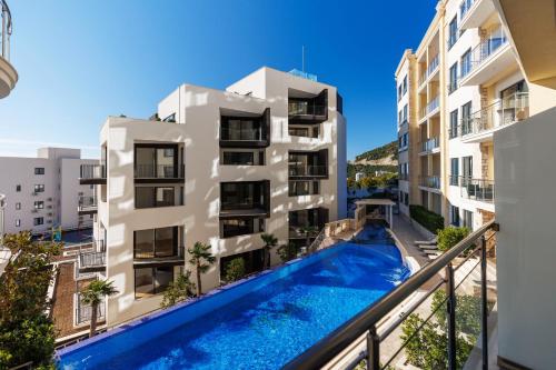 an apartment with a swimming pool in a building at The Dream Getaway & Spa by DeVasco in Becici