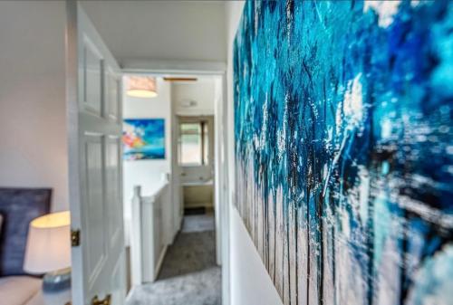 a hallway with a large painting on the wall at Petsol Apartments in Birmingham