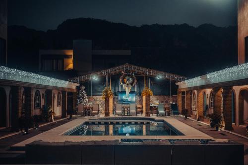 a building with a swimming pool at night at Casa Arcos Tepoztlán in Tepoztlán