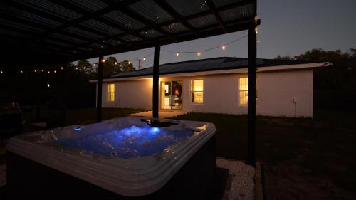 a hot tub in front of a house at night at Rainbow River Springs Dunnellon in Dunnellon