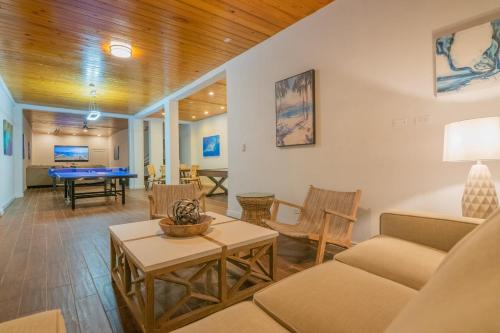 a living room with a couch and a table at Luxury Beachfront Villa On The Sand With Pool in Hartswell