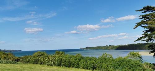 a view of a lake with trees and the sky at Maison familiale 6 chambres, vue imprenable in Pléboulle