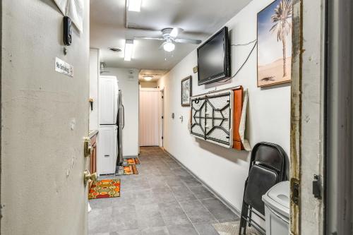 a hallway with a refrigerator and a tv on the wall at 1 Mi to Dtwn Remote Work-Friendly Apt in Hampton! in Hampton