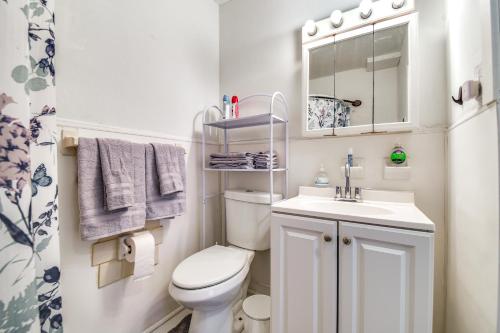 a small bathroom with a toilet and a sink at 1 Mi to Dtwn Remote Work-Friendly Apt in Hampton! in Hampton