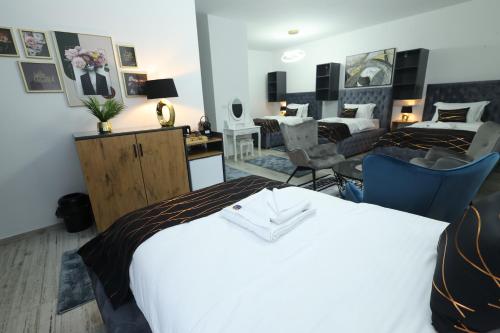 a hotel room with two beds and a living room at Golden Hill Palace in Novi Pazar