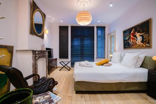 a bedroom with a bed and a large window at Circa 1929 in Ostend