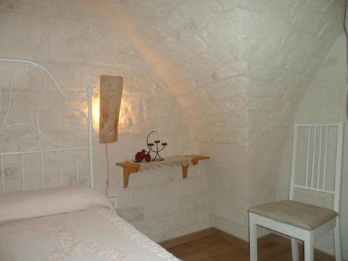 a bedroom with a bed and a shelf on the wall at Palazzo delle favole in Ostuni