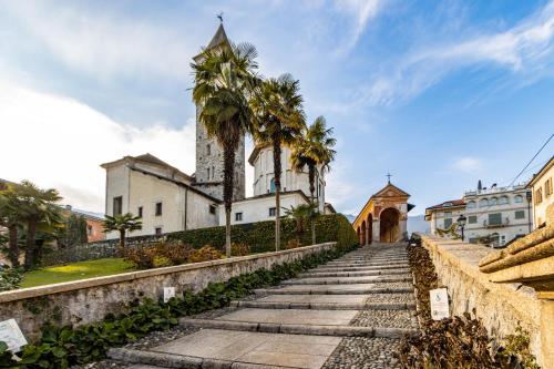 an old church with palm trees in front of it at Elm Alley Apartment - Baveno - Free Wi-Fi in Baveno
