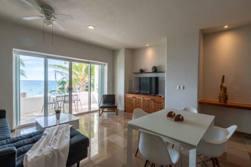 a living room with a couch and a table at 2 BR Apartment sea view in Puerto Aventuras