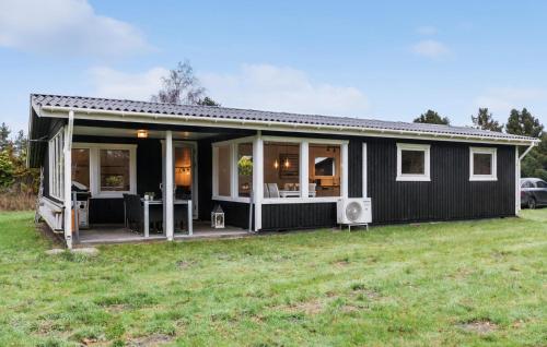 a black house with a large yard at 1 Bedroom Amazing Home In Gedser in Gedser
