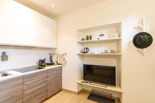 a small kitchen with a sink and a stove at Elm Alley Apartment - Baveno - Free Wi-Fi in Baveno