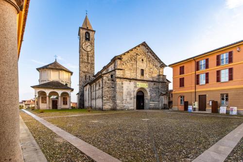 an old building with a clock tower in a city at Elm Alley Apartment - Baveno - Free Wi-Fi in Baveno