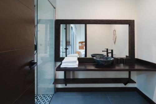 un baño con lavabo y espejo en Casa Asana 5 Luxe Retreat Tulum, en Tulum
