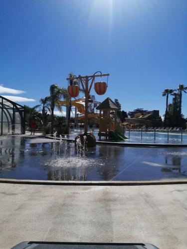 une fontaine dans un parc planté de palmiers dans l'établissement Mobil Home, à Torreilles