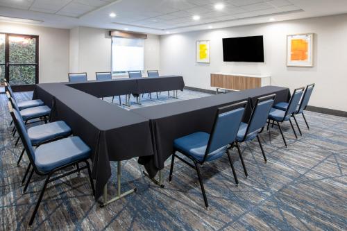 a conference room with a long table and chairs at Holiday Inn Express & Suites Lathrop by IHG in Lathrop