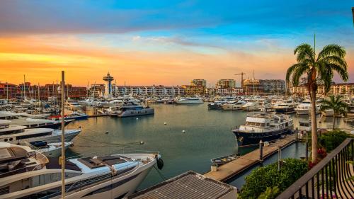 a group of boats docked in a marina at sunset at 2BR Marina Condo in Puerto Vallarta