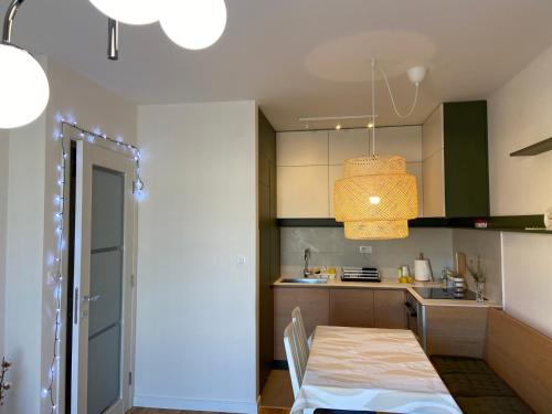 a small kitchen with a table and a dining room at Cozy one bedroom apartment in Podgorica