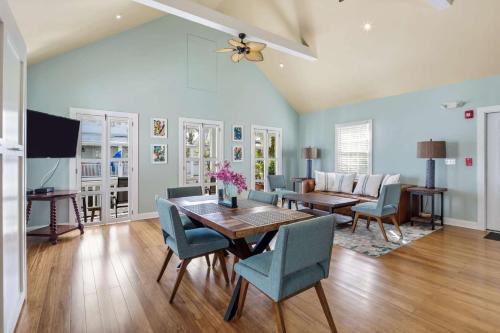 a dining room with a table and chairs and a couch at Sky Suite On Duval in Key West