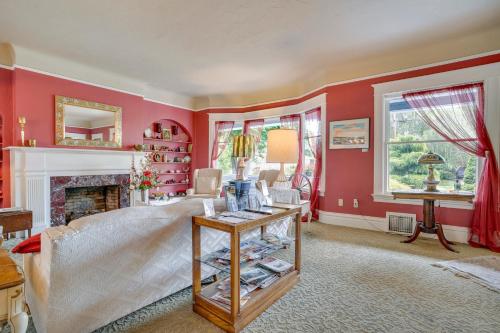 a living room with red walls and a fireplace at Wine Country Home with Yard Walk to Downtown! in Walla Walla