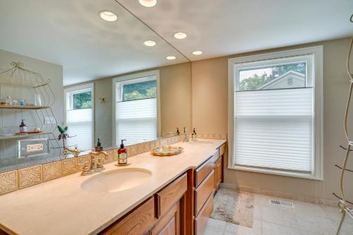 a bathroom with a sink and a large mirror at Wine Country Home with Yard Walk to Downtown! in Walla Walla