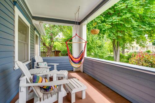 a porch with two chairs and a hammock at Wine Country Home with Yard Walk to Downtown! in Walla Walla