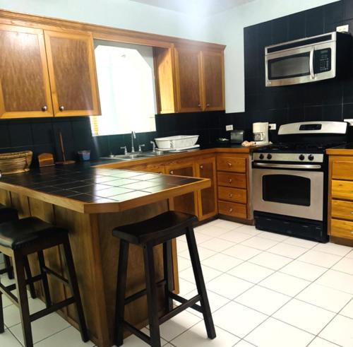 a kitchen with a stove and a counter top at Winter Haven Inn in Clarence Town