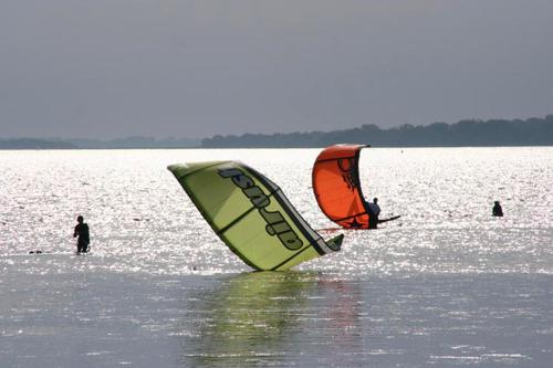 two people windsurfing in a large body of water at Herrenhaus Blengow App.06 in Blengow