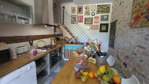 a kitchen with a bunch of fruit on a counter at Gite La Pipistrelle in Rudeau-Ladosse