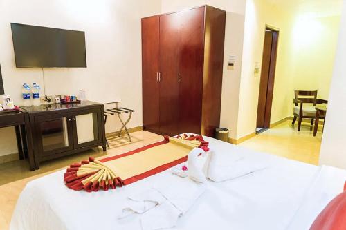 a hotel room with a bed and a television at FARS Hotel & Resorts - BAR-Buffet-Pool-SPA in Dhaka