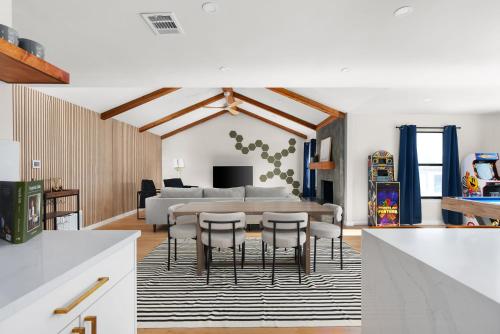a kitchen and living room with a table and chairs at Charming Modern Retreat in the Heart of Austin in Austin