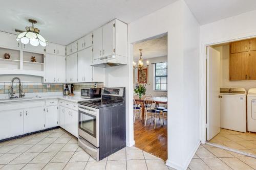 a kitchen with white cabinets and a stove top oven at Steps to Beach Carrabelle Family Home with Patio! in Big Blackjack Landing
